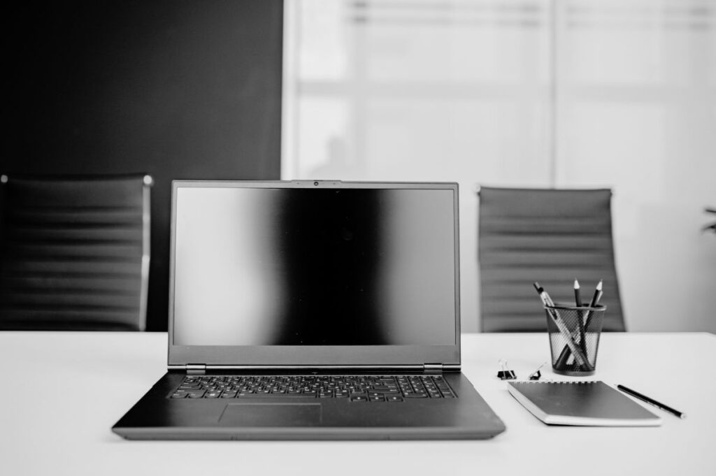 Laptop on a boardroom table, set up for a client strategy session